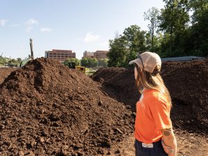 Ella Dohrmann stands in front of a pile of compost at the University of Tennessee Compost Facility. July 18, 2026.